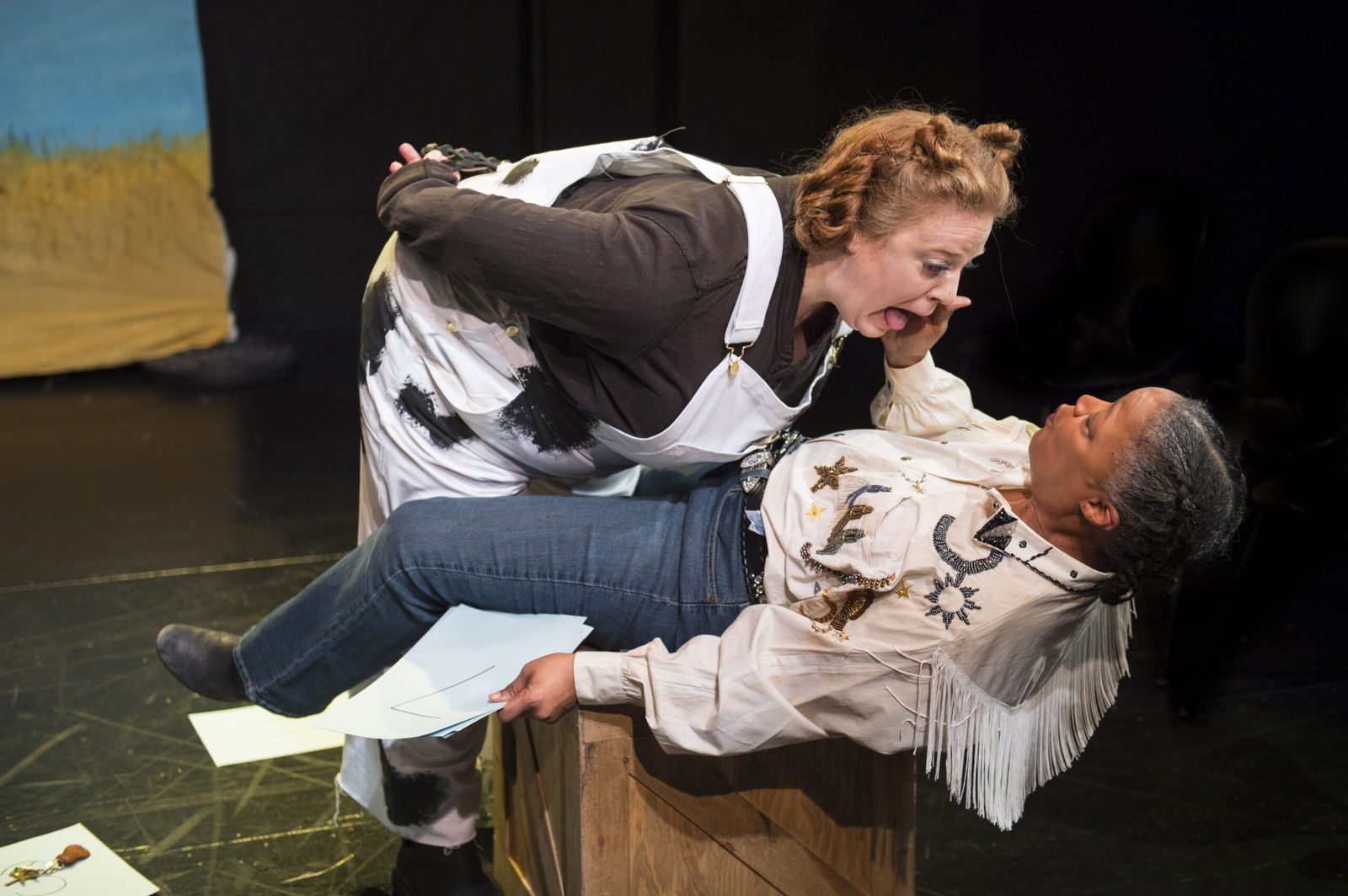 Kelly’s (Cathleen Riddley, right) attempts to teach a cow to count go off the rails when Maybelle (Gwen Loeb, left) has other priorities in the world premiere of Cow Pie Bingo by Larissa FastHorse Jeanette Harrison Named The New Artistic Director at Artists Rep